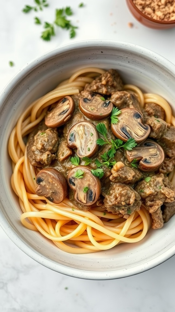 A bowl of beef stroganoff pasta with mushrooms and herbs.